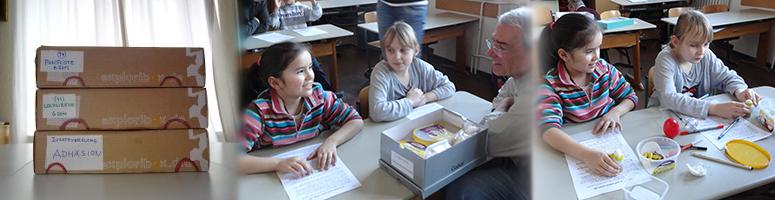 Sprach- und Sachkisten (Maße: 40 x 25 x 12 cm)  –  Kinder beim Lesen der Versuchsanleitung  –  beim Bauen und Experimentieren